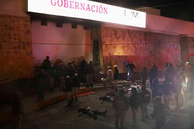 Firefighters and police rescue migrants from an immigration station in Ciudad Juarez, Chihuahua state on March 27, 2023, where at least 39 people were killed and dozens injured after a fire at the immigration station.  (Photo by HERIKA MARTINEZ/AFP via Getty Images)