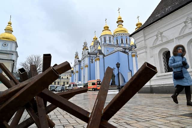 A woman leaves the Mykhailo Golden Domes Cathedral in Kyiv after a service for Ukrainians who have died as a result of the Russian invasion (Picture: Sergei Supinsky/AFP via Getty Images)