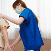 A nurse helps an elderly patient. Picture: Getty Images