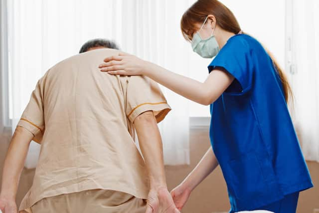 A nurse helps an elderly patient. Picture: Getty Images