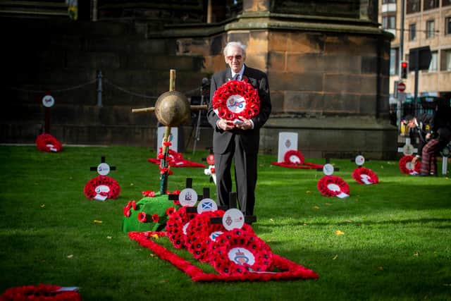 James White, 96, lays the Legion Scotland 100 Centenary wreath at the Garden of Remembrance today with son Jefferey White, 67, providing a helping hand.