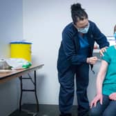 Nurse Sarah MacLeod, from the Vaccination Team, gives Margaret Swift, aged 69, from Balgreen, Edinburgh, her vaccine at the coronavirus mass vaccine centre at the Edinburgh International Conference Centre  on February 1, 2021 in Edinburgh. Photo by Jane Barlow - Pool/Getty Images