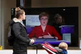 A member of the public walks past a TV screen at The Sound Counsel in Edinburgh as Nicola Sturgeon takes part in a virtual sitting of the Scottish Parliament (Picture: Andrew Milligan/PA Wire)