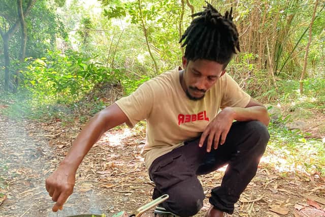 Joachim Joseph cooking a vegan meal in the forest. Pic: Hannah Stephenson/PA.