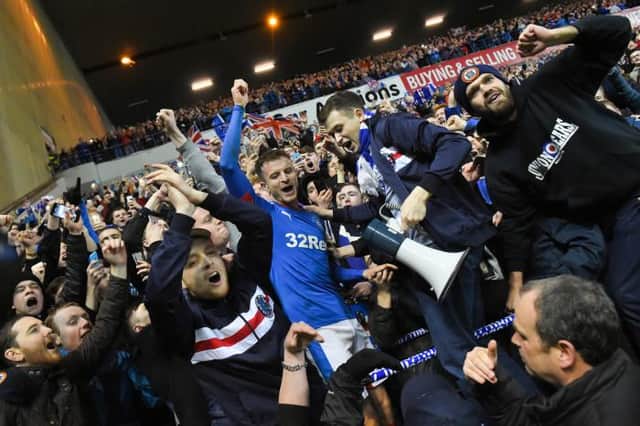 Rangers' Andy Halliday celebrates with the fans.