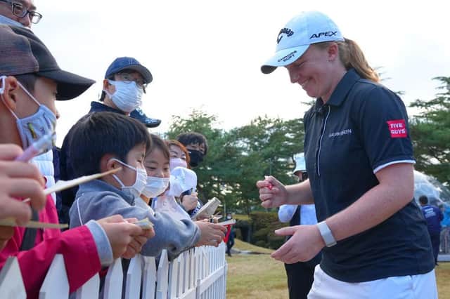 Gemma Dryburgh signs autographs for fans after completing her third round in the TOTO Japan Classic at Seta Golf Course in Shiga. Picture: Yoshimasa Nakano/Getty Images.
