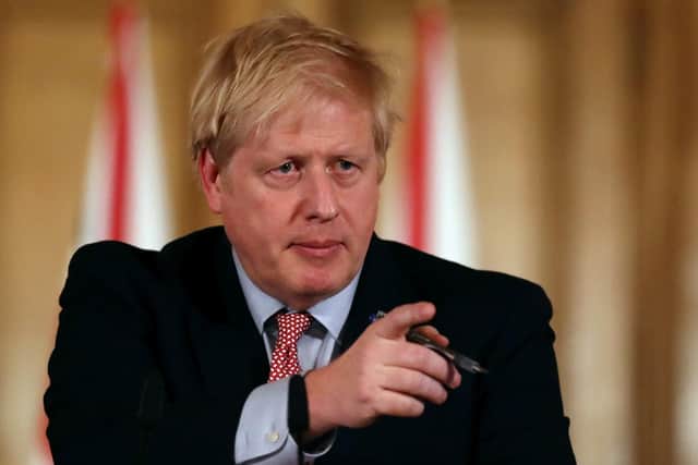 British Prime Minister Boris Johnson gestures during a news conference addressing the government's response to the coronavirus outbreak on March 12, 2020 in London, England. (Photo by Simon Dawson-WPA Pool/Getty Images)