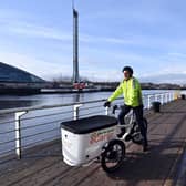 The Scotsman transport correspondent Alastair Dalton trying out an electric cargo bike on a cycle path beside the Clyde in Glasgow. Picture: John Devlin