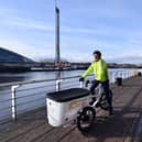 The Scotsman transport correspondent Alastair Dalton trying out an electric cargo bike on a cycle path beside the Clyde in Glasgow. Picture: John Devlin