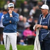 Calum Hill of Scotland and his caddie Phil "Wobbly" Morbey look on from the 18th green in the final round of the Betfred British Masters hosted by Sir Nick Faldo at The Belfry. Picture: Ross Kinnaird/Getty Images.