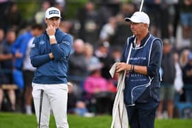 Calum Hill of Scotland and his caddie Phil "Wobbly" Morbey look on from the 18th green in the final round of the Betfred British Masters hosted by Sir Nick Faldo at The Belfry. Picture: Ross Kinnaird/Getty Images.