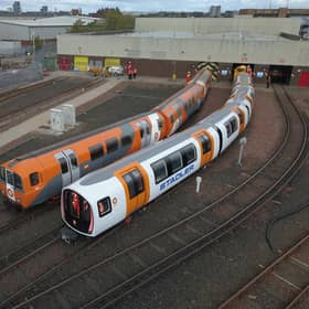 One of the new driverless trains, right, beside a current train. Picture: SPT