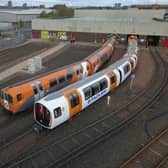 One of the new driverless trains, right, beside a current train. Picture: SPT