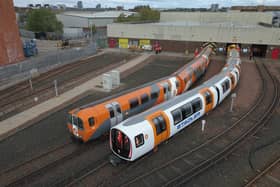 One of the new driverless trains, right, beside a current train. Picture: SPT