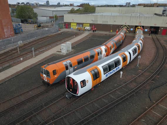 One of the new driverless trains, right, beside a current train. Picture: SPT
