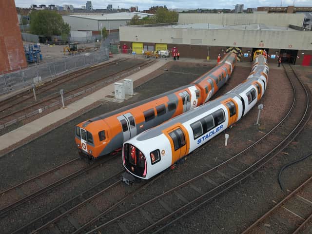 One of the new driverless trains, right, beside a current train. Picture: SPT