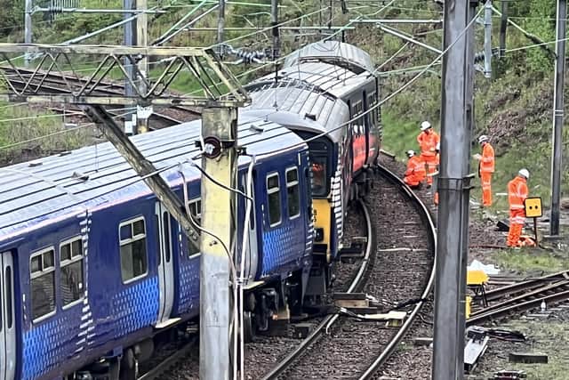 Network Rail engineers working to re-rail the train. Picture: Lisa Ferguson