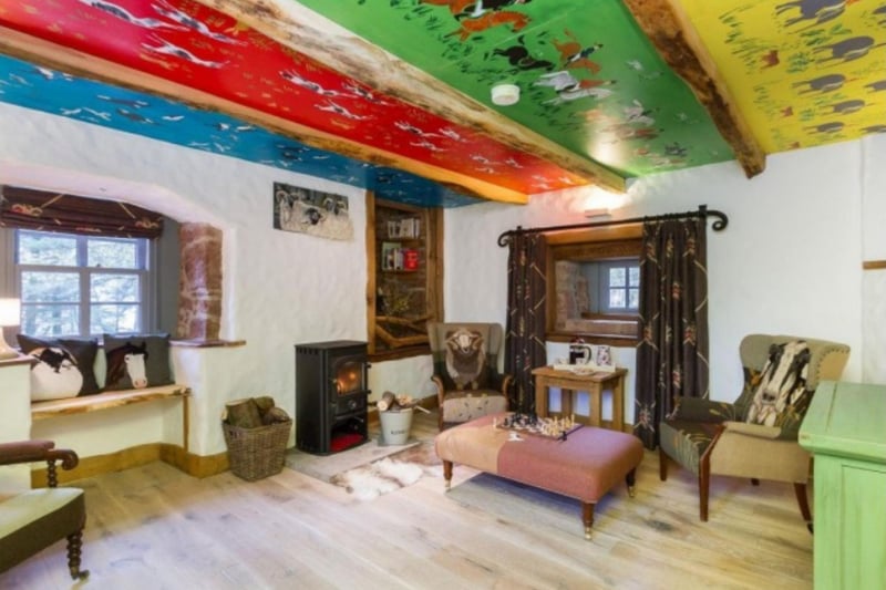 The first living room features a fun, brightly-coloured ceiling.