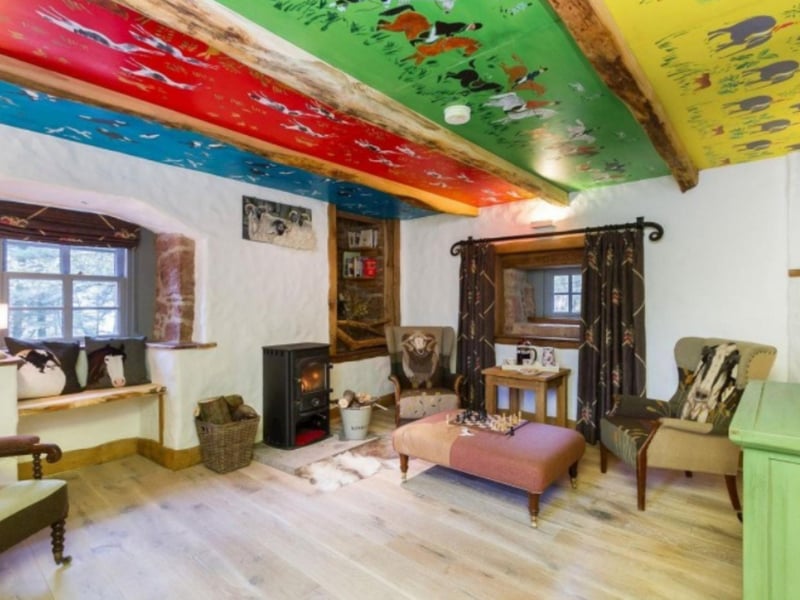 The first living room features a fun, brightly-coloured ceiling.