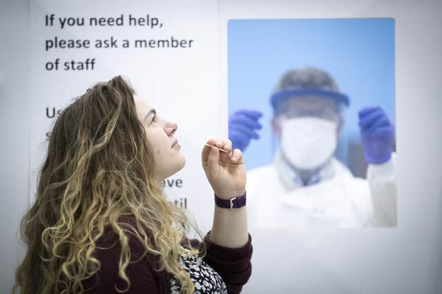 A woman takes a lateral flow Covid-19 test. Picture: PA Media