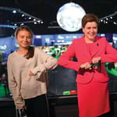 Scotland's First Minister Nicola Sturgeon poses for a photograph during her meeting with climate activists Vanessa Nakate (R) and Greta Thunberg during the COP26 UN Climate Change Conference.