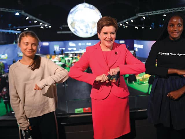 Scotland's First Minister Nicola Sturgeon poses for a photograph during her meeting with climate activists Vanessa Nakate (R) and Greta Thunberg during the COP26 UN Climate Change Conference.