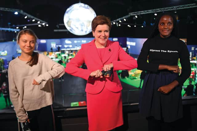 Scotland's First Minister Nicola Sturgeon poses for a photograph during her meeting with climate activists Vanessa Nakate (R) and Greta Thunberg during the COP26 UN Climate Change Conference.