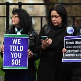 Demonstrators hold placards during a protest outside of Bute House, as Nicola Sturgeon announces her resignation. Picture: Andy Buchanan/AFP via Getty Images