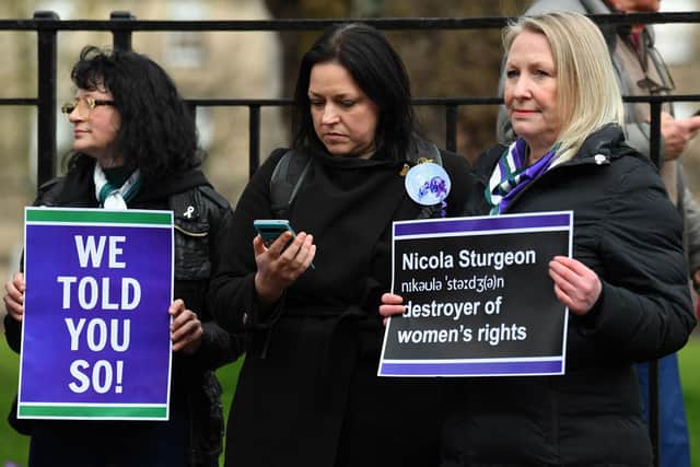 Demonstrators hold placards during a protest outside of Bute House, as Nicola Sturgeon announces her resignation. Picture: Andy Buchanan/AFP via Getty Images