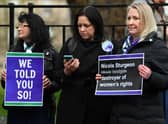 Demonstrators hold placards during a protest outside of Bute House, as Nicola Sturgeon announces her resignation. Picture: Andy Buchanan/AFP via Getty Images