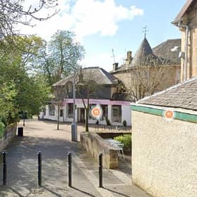 The two were found dead in a property on Station Road, Milngavie (Photo: Google Maps).