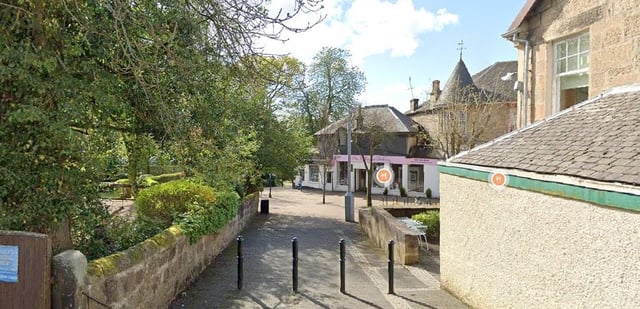 The two were found dead in a property on Station Road, Milngavie (Photo: Google Maps).