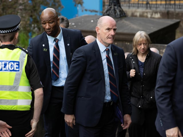 Former Rangers players Marvin Andrews (L) and Gordon Durie arrive at the funeral of Rangers kitman Jimmy Bell