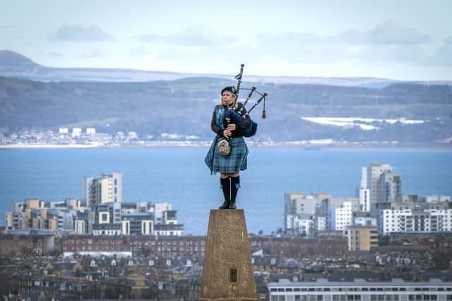 iper Louise Marshall plays her 95-year-old Robertson bagpies, that used to belong to her late father William Marshall, at the top of Calton Hill in Edinburgh. Picture: Jane Barlow/PA Wire