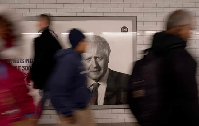The face of former British prime minister Boris Johnson on an advertising hoarding at Westminster tube station in London. Picture: AP Photo/Alberto Pezzali