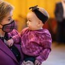 Nicola Sturgeon meets Amelia Mackinnon, nine months, last year at Govan Help, a charity which supports vulnerable children, parents and families (Picture: Peter Summers/Getty Images)