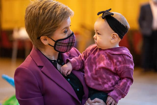 Nicola Sturgeon meets Amelia Mackinnon, nine months, last year at Govan Help, a charity which supports vulnerable children, parents and families (Picture: Peter Summers/Getty Images)