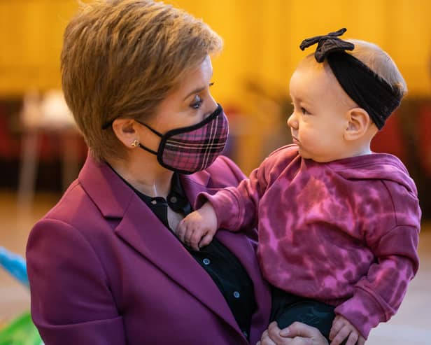 Nicola Sturgeon meets Amelia Mackinnon, nine months, last year at Govan Help, a charity which supports vulnerable children, parents and families (Picture: Peter Summers/Getty Images)
