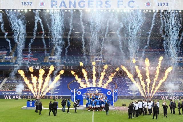 Fireworks accompany Rangers' title celebrations at Ibrox as James Tavernier lifts the Premiership trophy aloft among his team-mates. (Photo by Rob Casey / SNS Group)