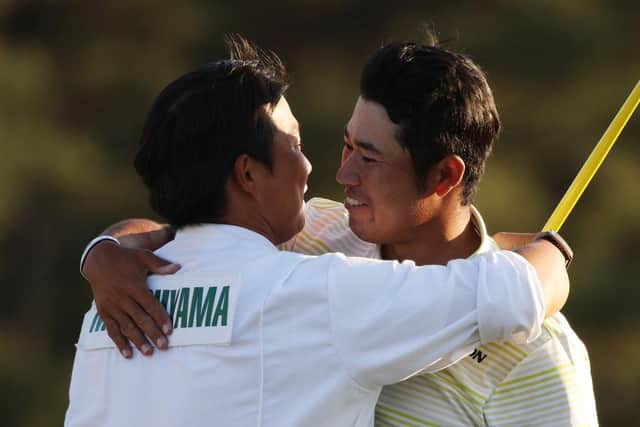 Hideki Matsuyama hugs his caddie, Shota Hayafuji, on the 18th green after winning the 2021 Masters at Augusta National Golf Club. Picture: Kevin C. Cox/Getty Images.