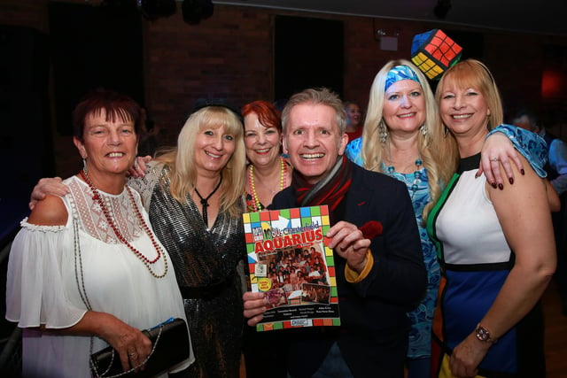 Author Neil Anderson with the book and fellow revellers
