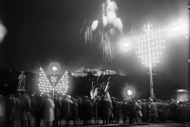 Crowds on Princes Street enjoying watching the fireworks to mark the opening of the 1963 Edinburgh Festival.