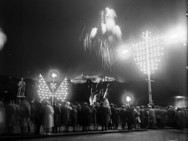 Crowds on Princes Street enjoying watching the fireworks to mark the opening of the 1963 Edinburgh Festival.