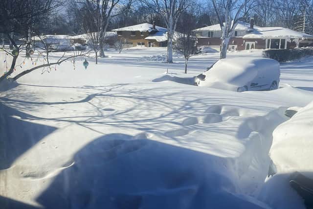 A car sits blanketed in snow on a driveway in Amherst, N.Y. Picture: AP Photo/Delia Thompson