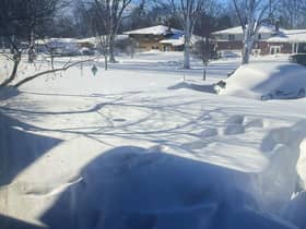 A car sits blanketed in snow on a driveway in Amherst, N.Y. Picture: AP Photo/Delia Thompson