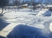 A car sits blanketed in snow on a driveway in Amherst, N.Y. Picture: AP Photo/Delia Thompson