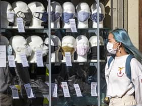 Face masks and social distancing are still with us, so shouldn't we be in a Covid tier? (Picture: Jane Barlow/PA Wire)