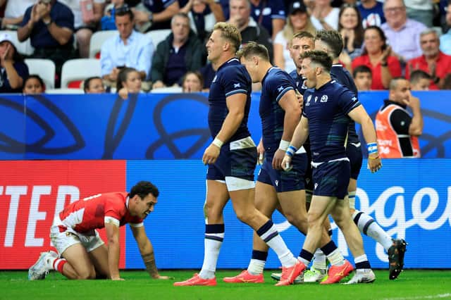 Scotland's scrum-half George Horne (R) celebrates with teammates after scoring a try against Tonga.