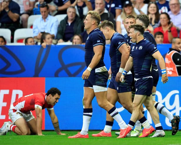 Scotland's scrum-half George Horne (R) celebrates with teammates after scoring a try against Tonga.