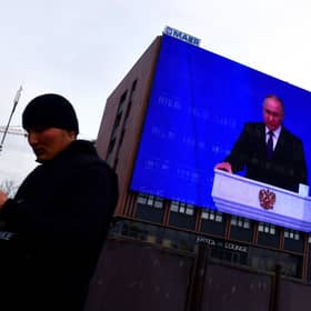 Vladimir Putin warned Russia could use nuclear weapons against the West during his state of the nation address, which was broadcast on giant screens in Moscow (Picture: Olga Maltseva/AFP via Getty Images)